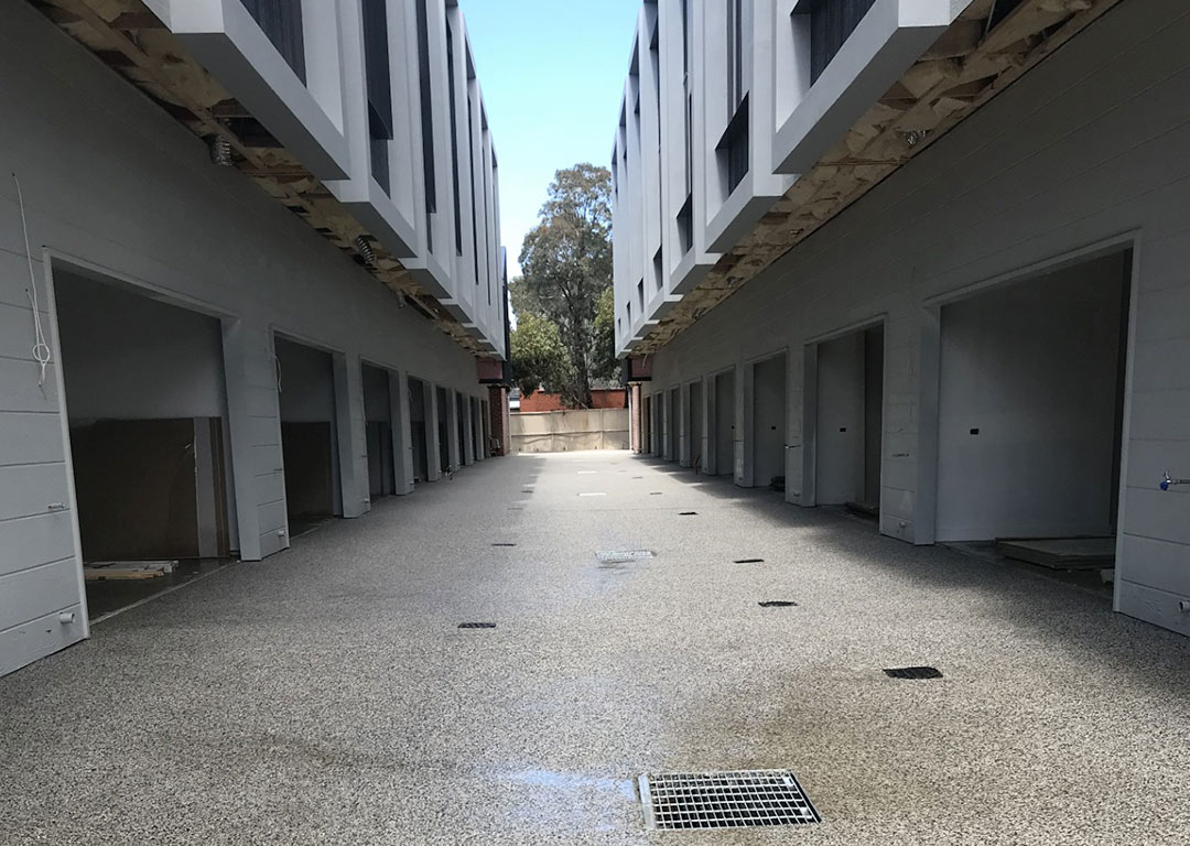 Newly installed permeable concrete driveway in front of a commercial building.