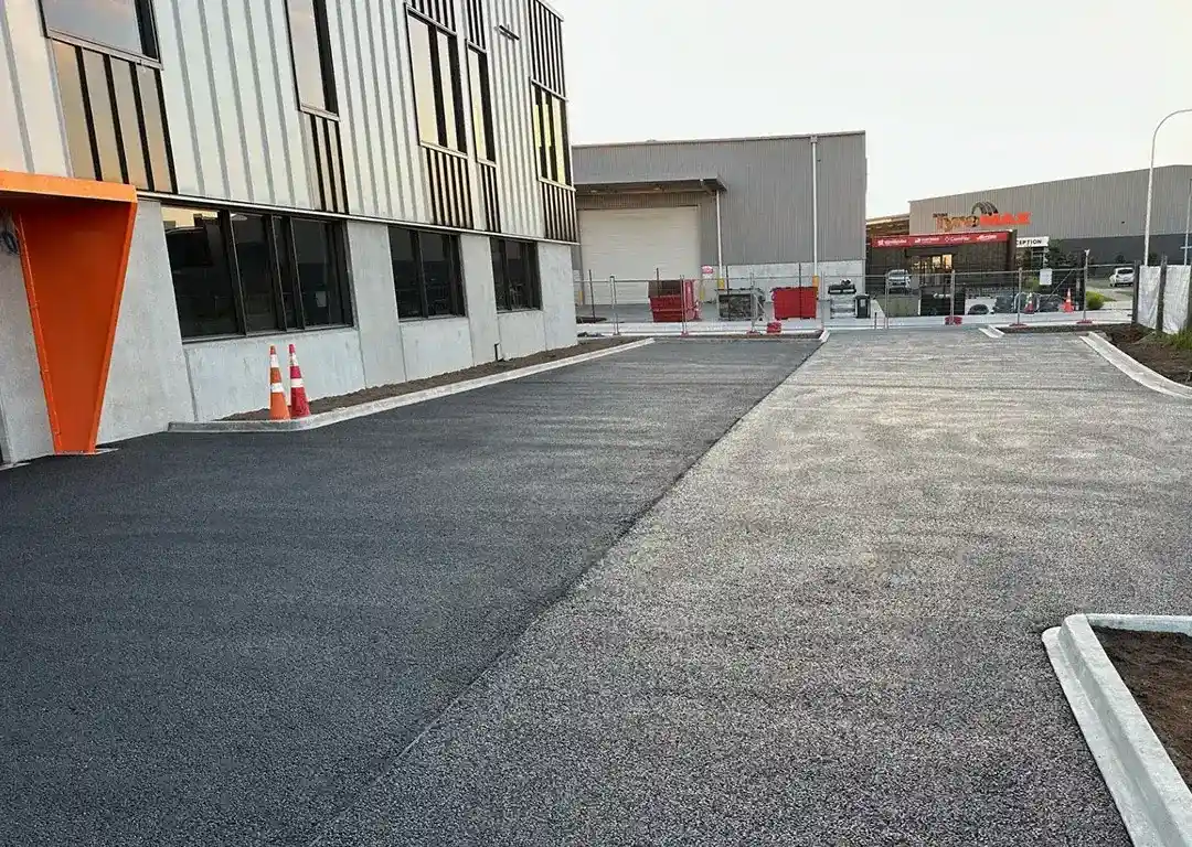 Newly installed permeable concrete driveway in front of a commercial building.