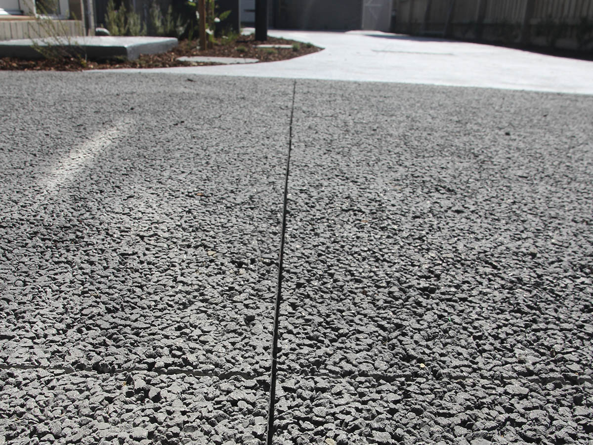 Projects-_0053_IMG_0145 Permeable concrete driveway in front of modern residential buildings.
